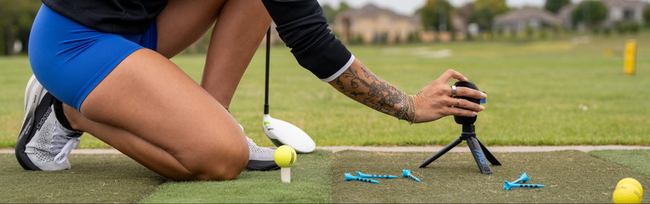 Woman on a golf course preparing for a putt with a putter.