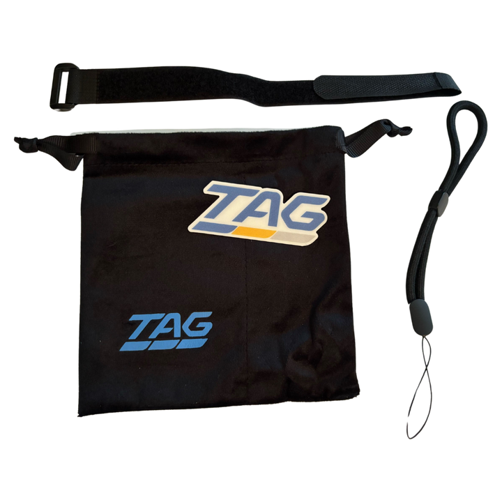 Black velvet drawstring bag with blue TAG text. Black velcro strap. Black lanyard. Blue, yellow, and grey TAG logo sticker.