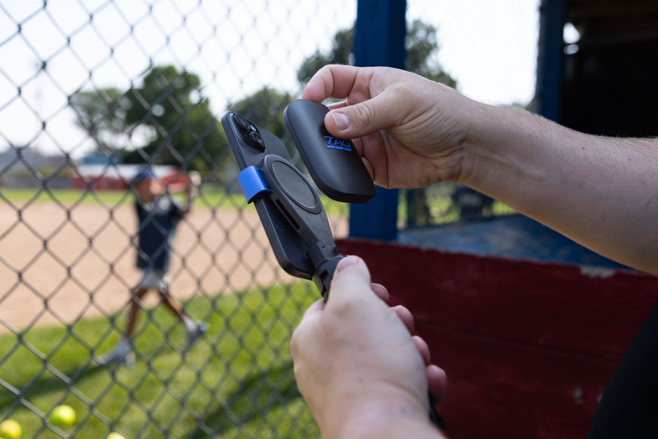 Coach assembling TAG One Sports Radar kit while youth baseball player warms up swing in background.