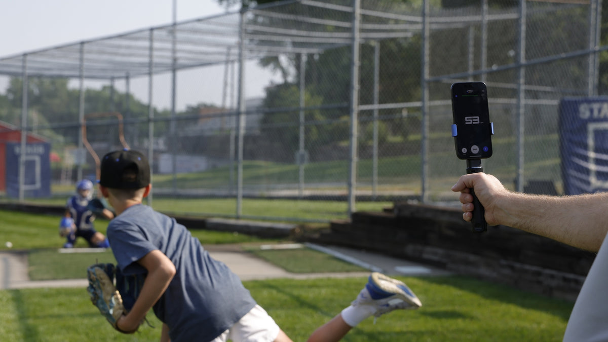 Pitcher throwing a baseball while speed being tracked with TAG One Radar.