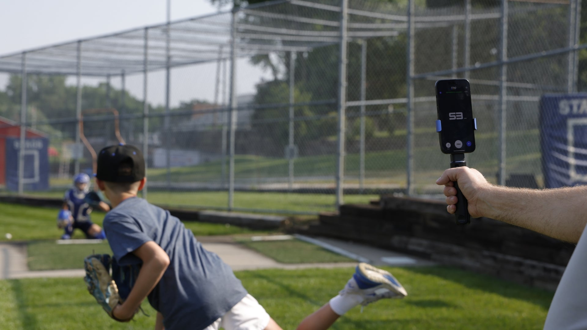 Pitcher throwing a baseball while speed being tracked with TAG One Radar.