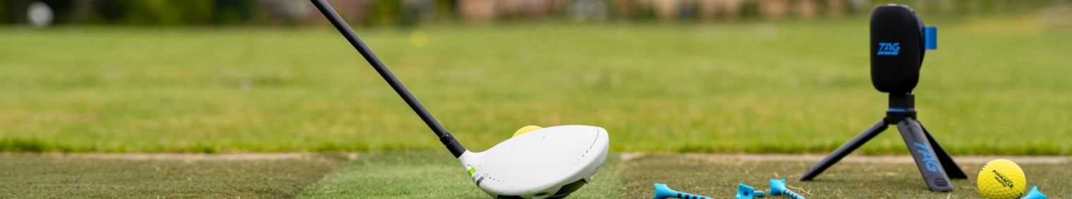 Golf club on a green surface with a blurred background
