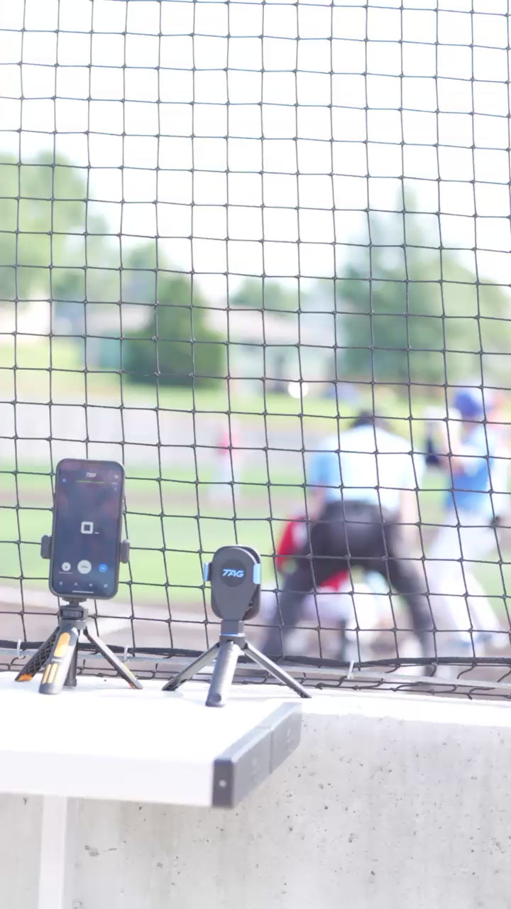 Baseball game being played with radar device capturing pitch speed.